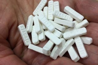 hand holding several xanax pills