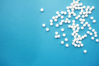 white pills over a blue background