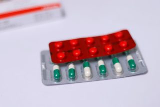red blister, green and white bilster of pills