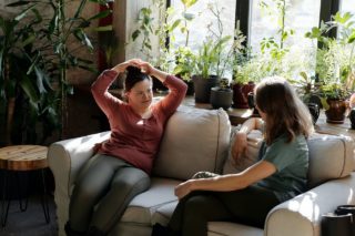 Women Sitting on the Couch Chatting
