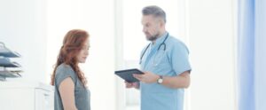 Doctor diagnosing a female patient
