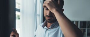 Upset man suffering from headache