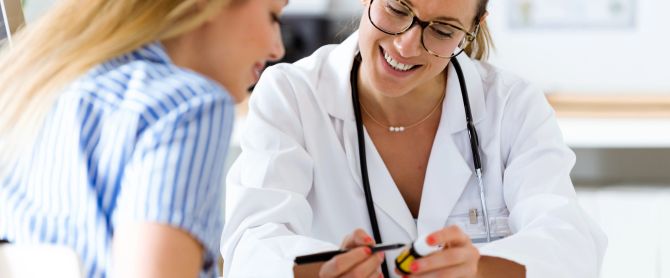 Female doctor prescribing medication for patient