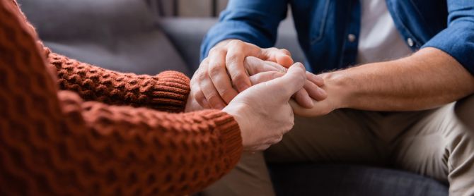 father and son holding hands while sitting at home