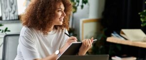 woman with curly hair reflects thoughtfully