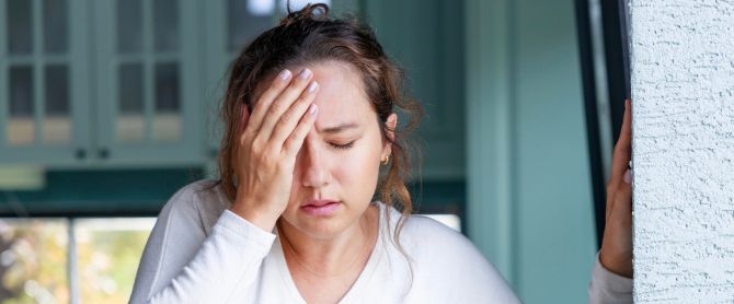 Young woman suffering from vertigo or dizziness