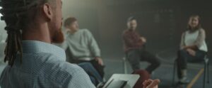 A group of adults engaged in a casual discussion indoors