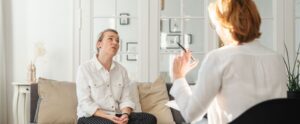 Two women converse during a therapy session