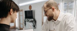 receptionist and client converse over an appointment