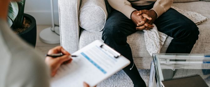therapist takes notes during a therapy session