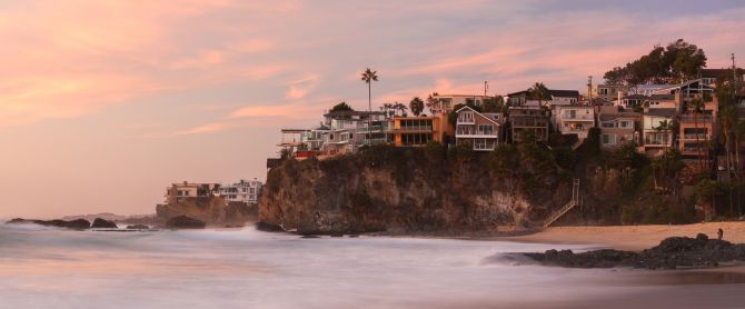 Laguna Beach cliffs against a vibrant sunset sky
