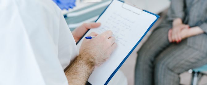 Medical professional writing patient notes