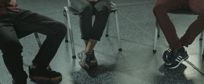 sitting in chairs during a discussion or support session indoors
