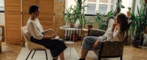 Two women sit in a therapy session