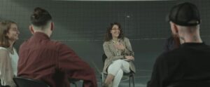 group of adults participate in a support group meeting