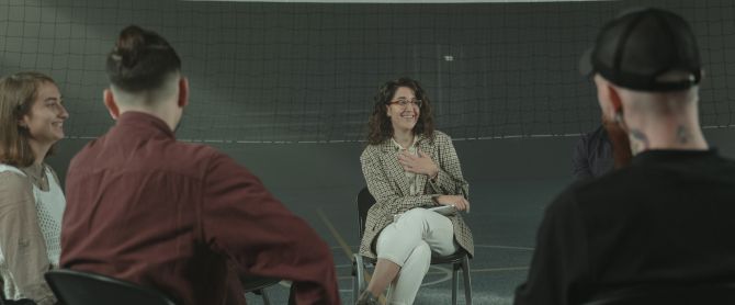 group of adults participate in a support group meeting